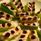 Ladybugs on a Log made with celery, raspberry cream cheese, and cranberries