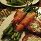 Prosciutto wrapped asparagus with creamy cheese filling on a plate