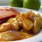 Golden sautéed apples with caramelized brown sugar sauce in a skillet