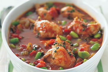 Mediterranean chicken casserole with tomatoes and herbs in a baking dish