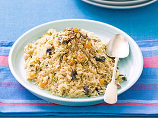 Fruity Rice Pilaf with dried apples and tomatoes in a serving bowl