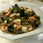 Cioppino seafood stew with tomatoes and fresh parsley in a bowl