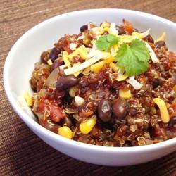 Steaming bowl of quinoa and black bean chili with vibrant toppings